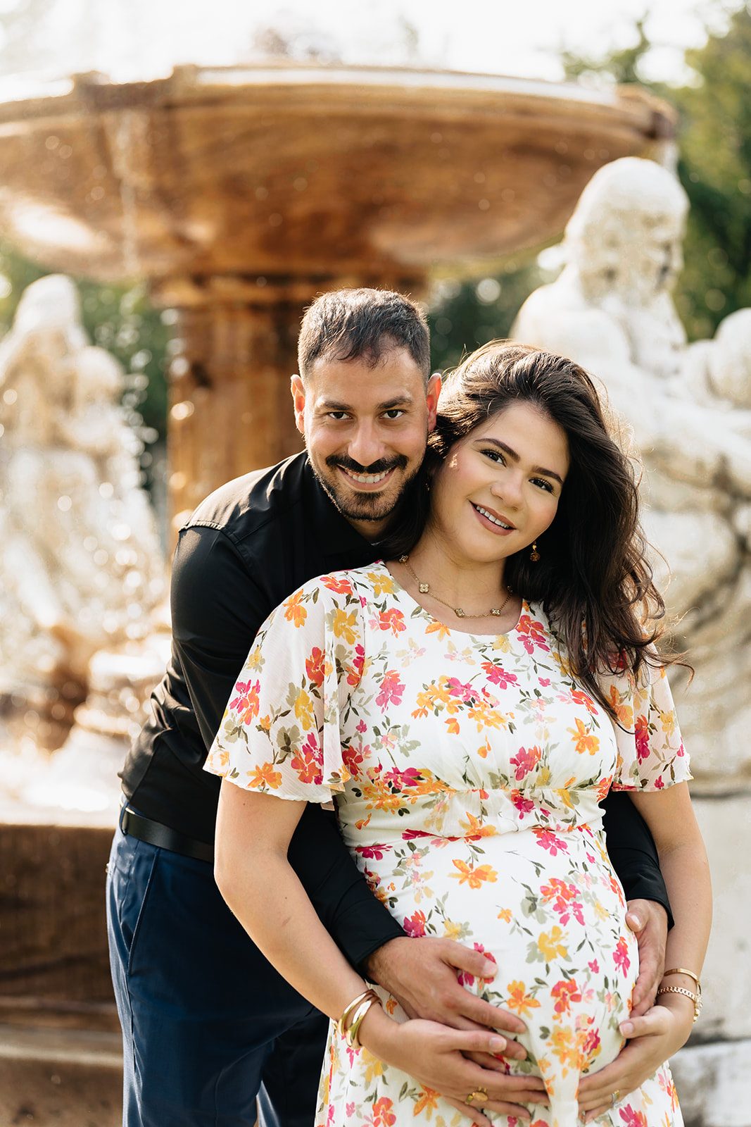 Hala and Abe standing together in front of the sculpted stone figures of the fountain at the Cleveland Museum of Art