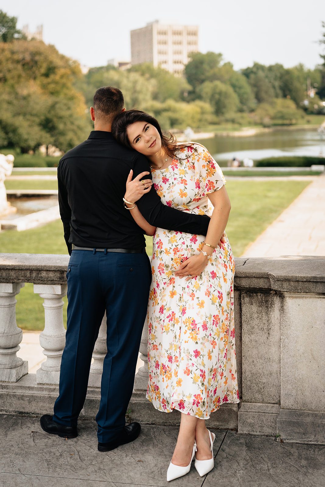 Hala and Abe leaning against the white stone railing of the terrace overlooking the lagoon at the Cleveland Museum of Art