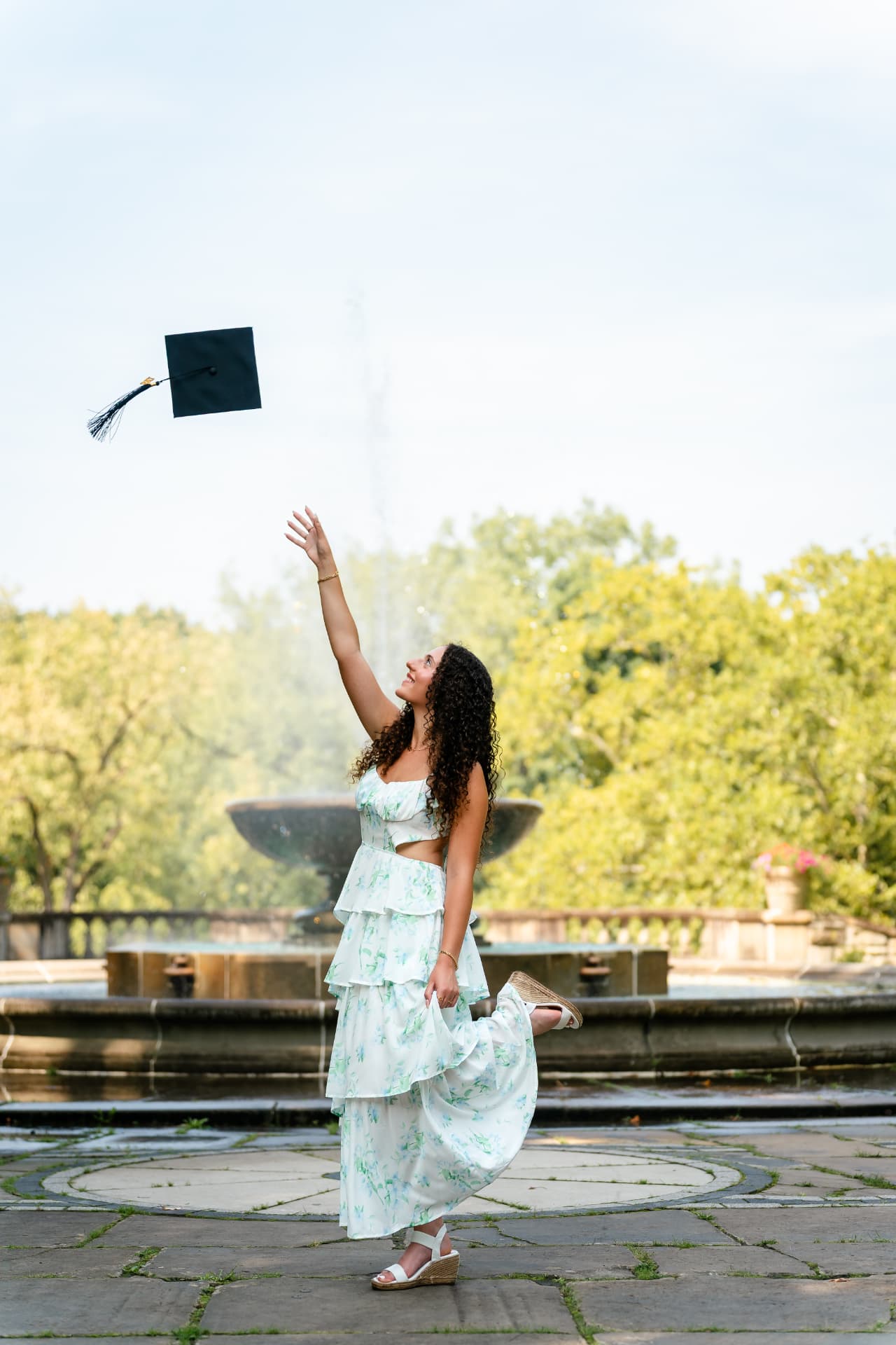 Naya tossing her graduation cap into the air during her senior portrait session in Cleveland