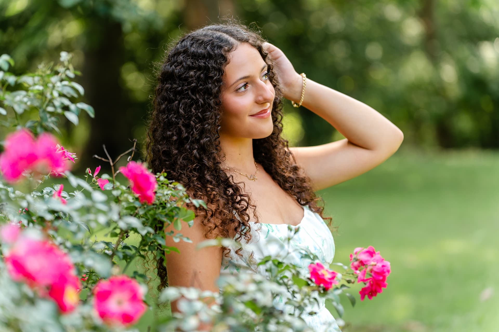 Naya surrounded by flowers and greenery in Cleveland's Hungarian Cultural Garden