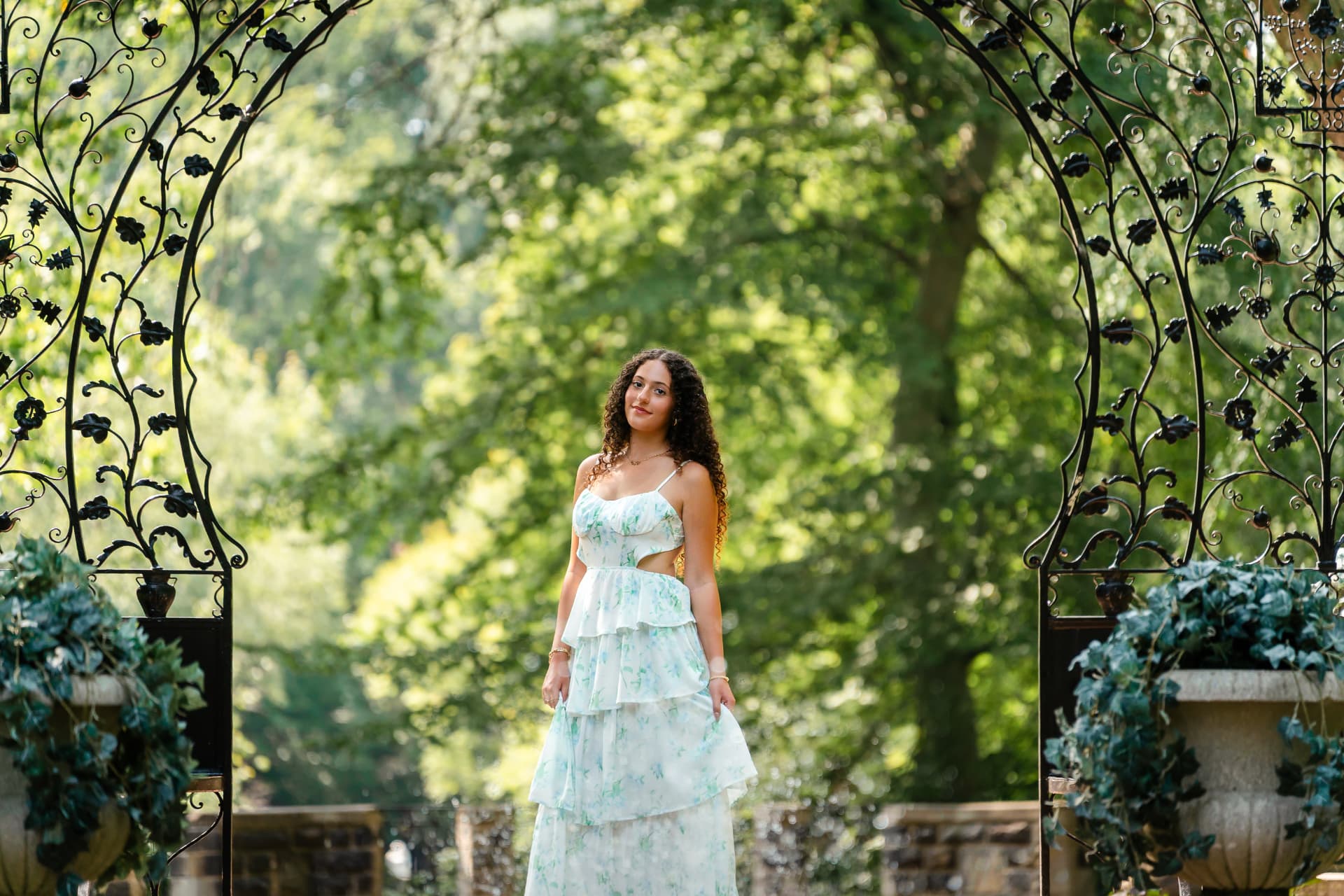 Naya photographed during her senior session in Cleveland's Cultural Gardens, framed by greenery and late-summer light